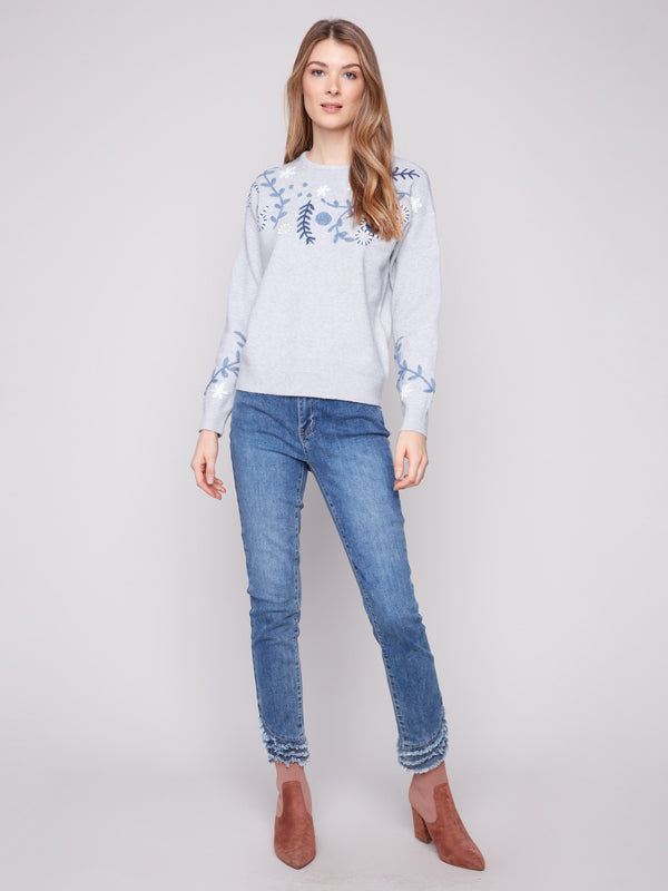 This stylish sweater features a drop shoulder design, offering a relaxed and modern fit by Charlie B.