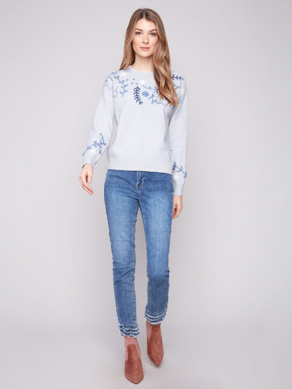 Experience the comfort of the drop shoulder design in this beautifully embroidered heather grey sweater by Charlie B.