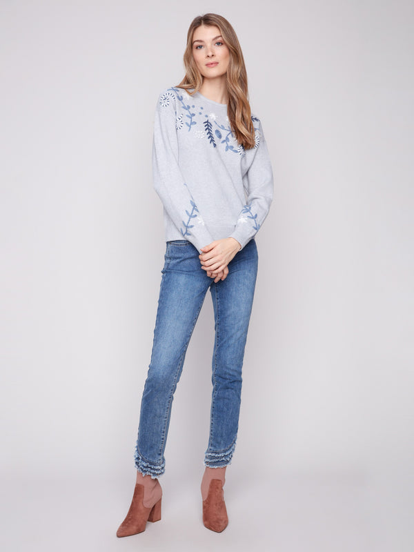 A versatile piece, this crew neck sweater showcases exquisite floral embroidery for an elegant touch by Charlie B.