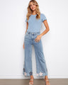 These jeans feature a stylish flared leg and floral embroidery for a chic look. Perfect for casual outings. By Charlie B.