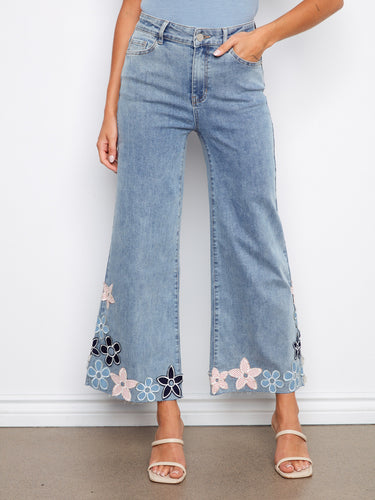 Five-pocket design meets stretch denim in these flared leg jeans, complete with eye-catching floral embroidery. By Charlie B.