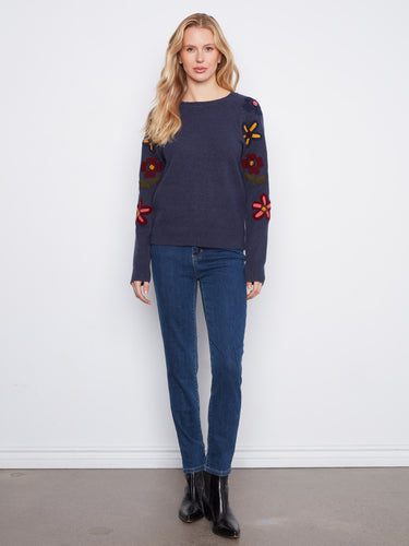 Adorned with an embroidered floral design, this sweater adds a touch of elegance to any outfit. A creation by Charlie B.