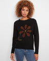 Black sweater with a crew neck and striking embroidered floral design, perfect for casual elegance by Charlie B.