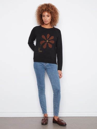 Elegant black sweater featuring long raglan sleeves and a beautiful floral embroidery by Charlie B.