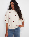 Soft brushed knit sweater with charming embroidered hearts, perfect for a cozy day. By Charlie B.