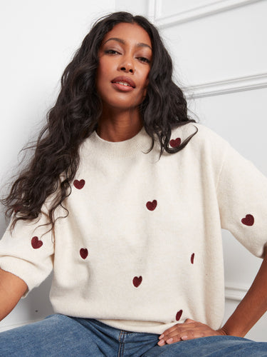 Mock neck design with balloon elbow sleeves and heart details adds a playful touch to your wardrobe. By Charlie B.