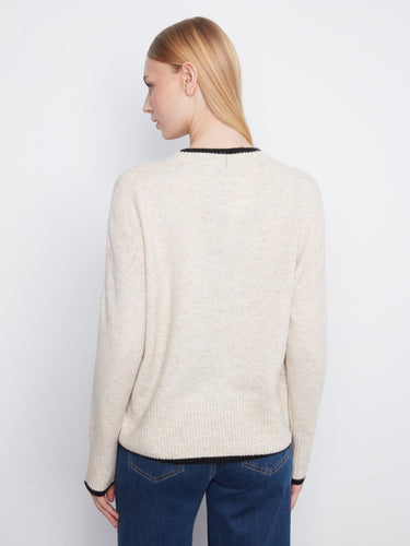 A playful heart embroidery graces the front of this soft knit sweater, making it a delightful wardrobe staple by Charlie B.
