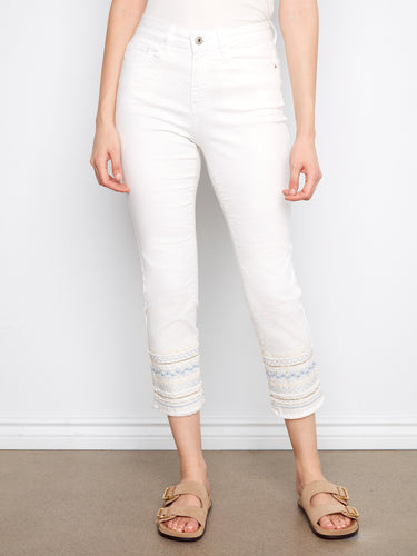 Elegant cropped white jeans featuring a five-pocket design and intricate hem embroidery, perfect for versatile styling by Charlie B.