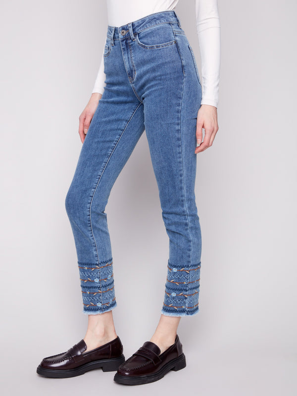 Embroidered hem detail adds a unique touch to these ankle-length medium blue jeans by Charlie B.