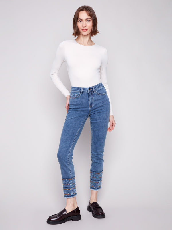 Ankle-length design enhances the sleek look of these medium blue embroidered hem jeans by Charlie B.
