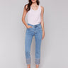 Light blue denim jeans with embroidered hems and a classic five-pocket design, featuring a slim fit by Charlie B.
