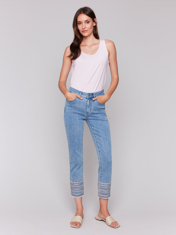Light blue denim jeans with embroidered hems and a classic five-pocket design, featuring a slim fit by Charlie B.