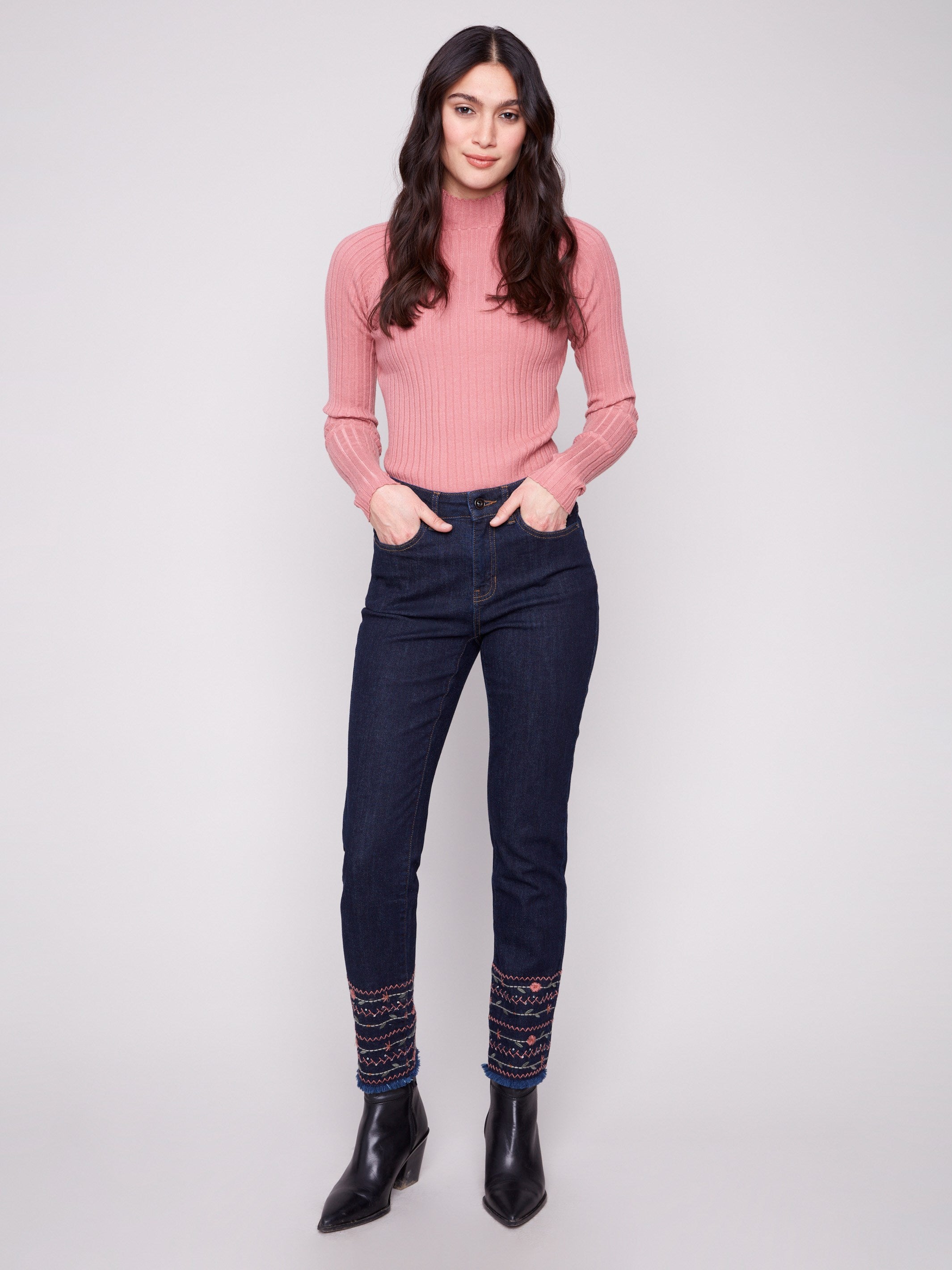 Deep blue jeans with a slim leg cut, featuring ankle-length design and intricate embroidery on the hem by Charlie B.