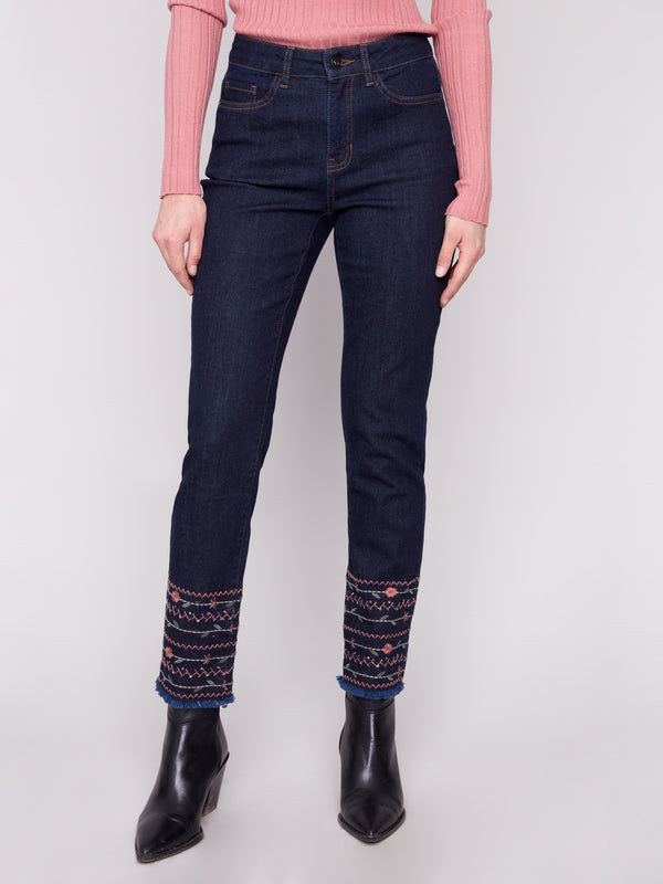 Stretch denim jeans in rich blue, showcasing a five-pocket design and detailed embroidered hems by Charlie B.