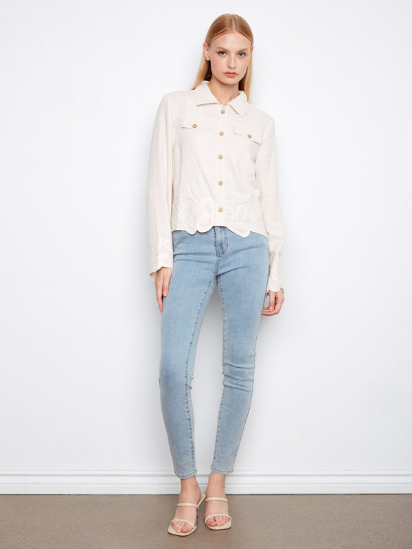 Elegant cream jacket showcasing faux flap pockets and intricate embroidery for added charm by Charlie B.