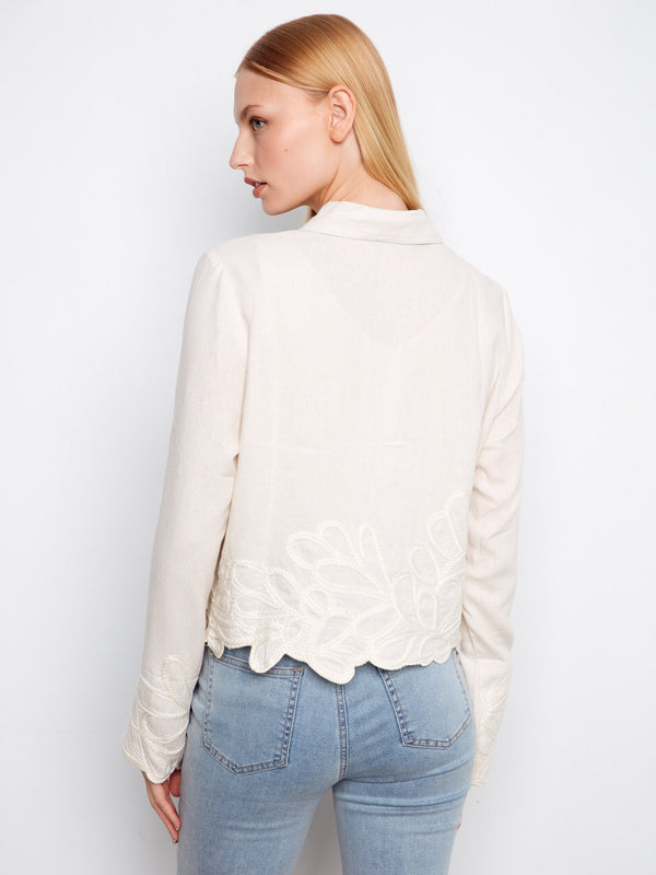 Sophisticated cream jacket featuring front button closure and delicate embroidery accents by Charlie B.