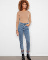 Medium blue slim leg jeans with stretch denim and intricate embroidery at the hem, complete with a button closure by Charlie B.