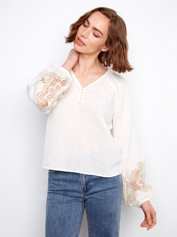 Linen blend blouse featuring intricate openwork lace on the sleeves, adding a touch of elegance by Charlie B.