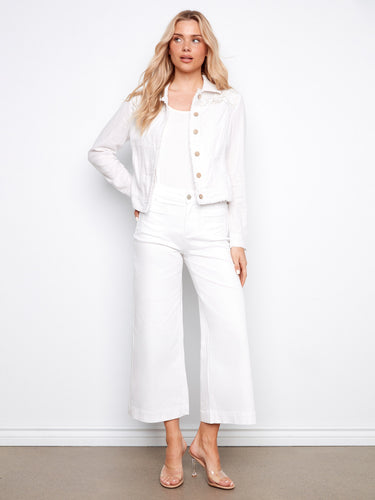 The frayed edges of this white linen jacket add a trendy flair to its classic silhouette, making it versatile for any look by Charlie B.