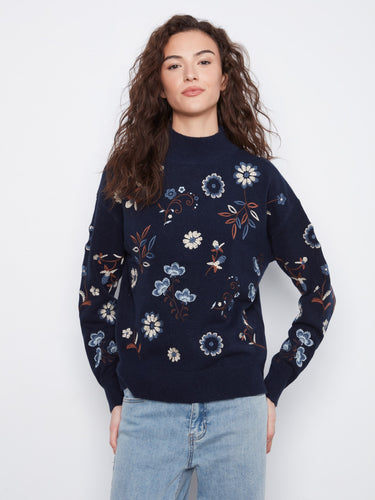 Navy sweater with floral embroidery and mock neck, featuring a stylish drop shoulder design for added comfort by Charlie B.