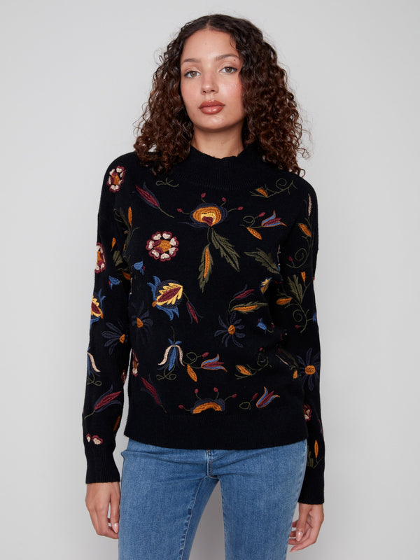 Elegant sweater with ribbed neck and hem, adorned with colorful floral designs for added flair by Charlie B.