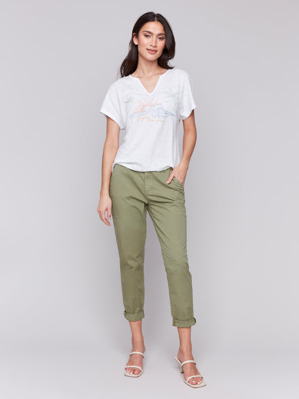 White linen blend top featuring short sleeves and intricate embroidery details by Charlie B.
