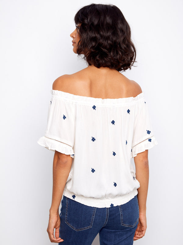 Elastic cuffs add to the relaxed fit of this embroidered off-the-shoulder top, making it a wardrobe essential by Charlie B.