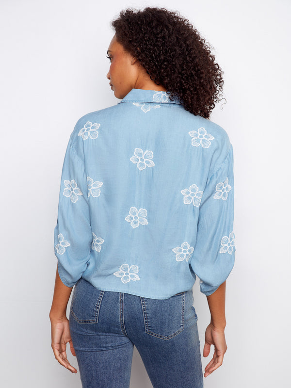 Floral embroidered blouse in light blue with elegant details including a collared neckline and chest pocket by Charlie B.