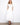 White V-neck dress featuring an empire elastic waist and hidden pockets by Charlie B.