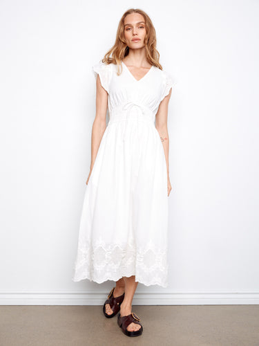 Sophisticated white V-neck dress with delicate embroidered hem by Charlie B.