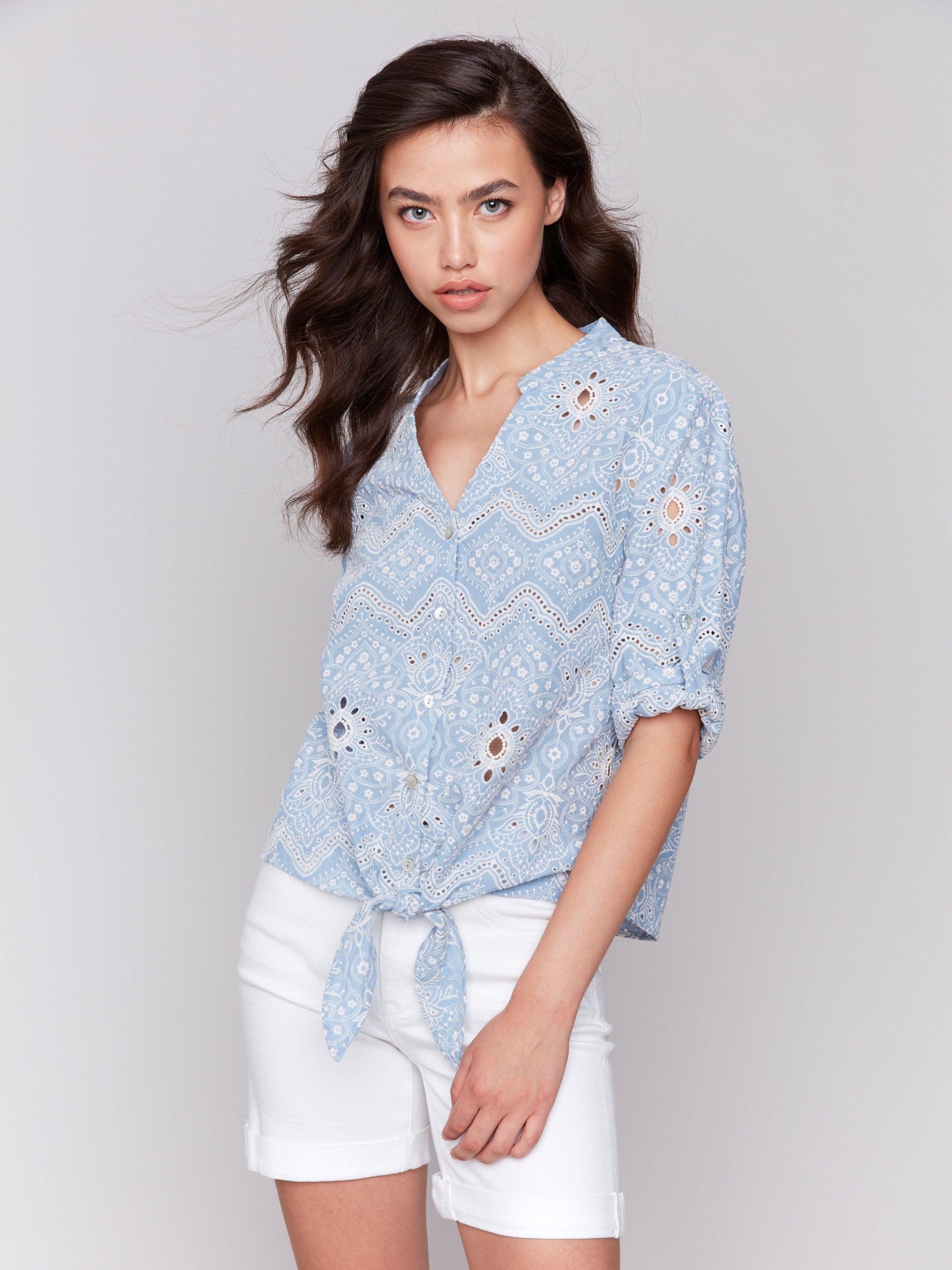 Blouse with front tie knot at hem, crafted in blue cotton by Charlie B.