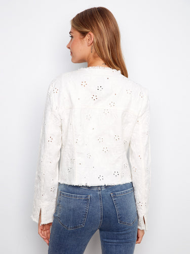 Chic white eyelet denim jacket designed with a frayed hem and convenient button front closure by Charlie B.