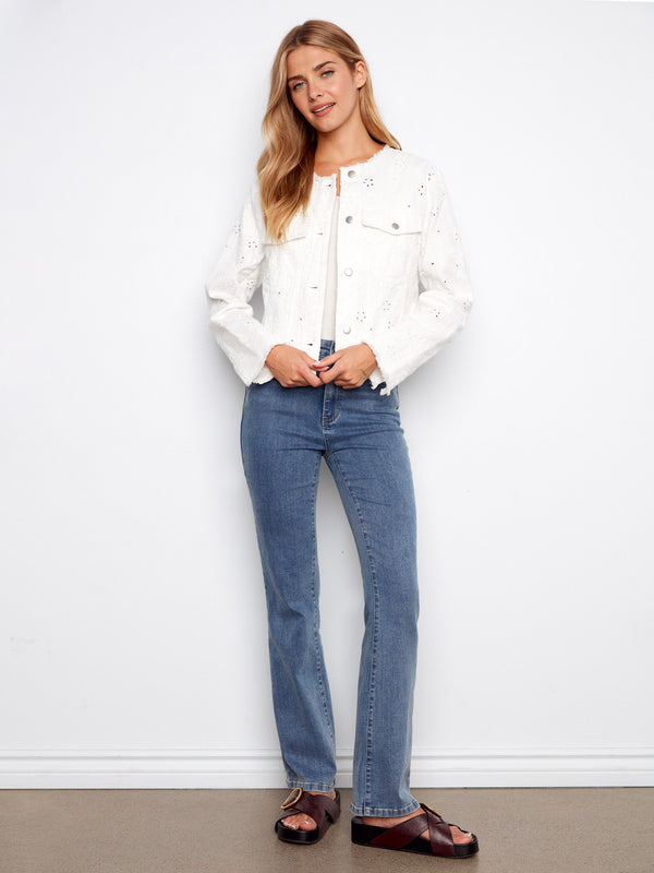 Trendy white denim jacket highlighted by its unique frayed hem and elegant button front closure by Charlie B.