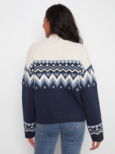 Comfortable sweater in a relaxed fit with drop shoulder design, highlighted by its unique patterns. Created by Charlie B.