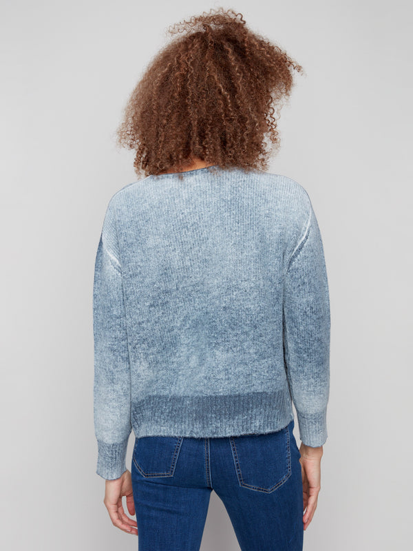 Chic blue denim sweater showcasing its soft texture and modern design elements by Charlie B.