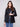 Stylish black faux leather blazer highlighted by welt pockets, combining practicality and fashion by Charlie B.