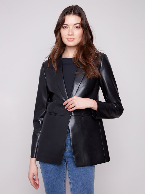 Stylish black faux leather blazer highlighted by welt pockets, combining practicality and fashion by Charlie B.