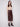 Cabernet faux leather midi skirt featuring side pockets, paired with a beige top and brown ankle boots by Charlie B.
