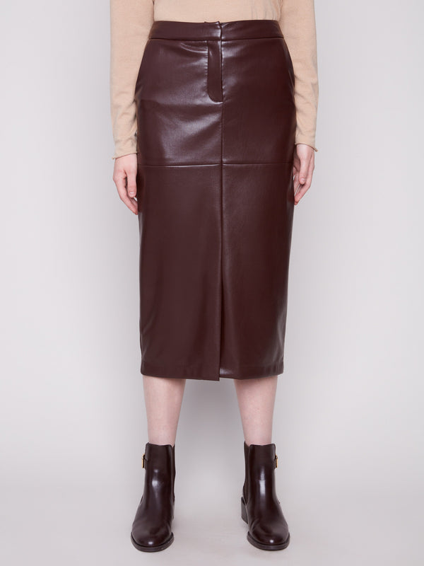 Cabernet faux leather midi skirt with a slit front hem, styled with a beige top and brown ankle boots by Charlie B.