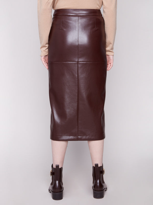 Cabernet faux leather midi skirt in classic midi length, matched with a beige top and brown ankle boots by Charlie B.