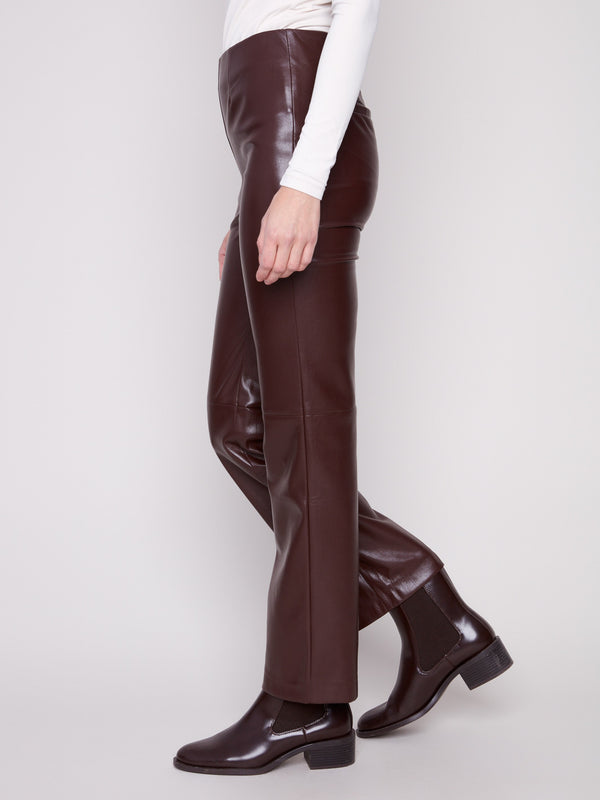 Elegant cabernet faux leather pants showcasing back welt pockets and a modern style by Charlie B.
