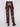 Stylish cabernet faux leather pants designed with seamless back welt pockets for added flair by Charlie B.