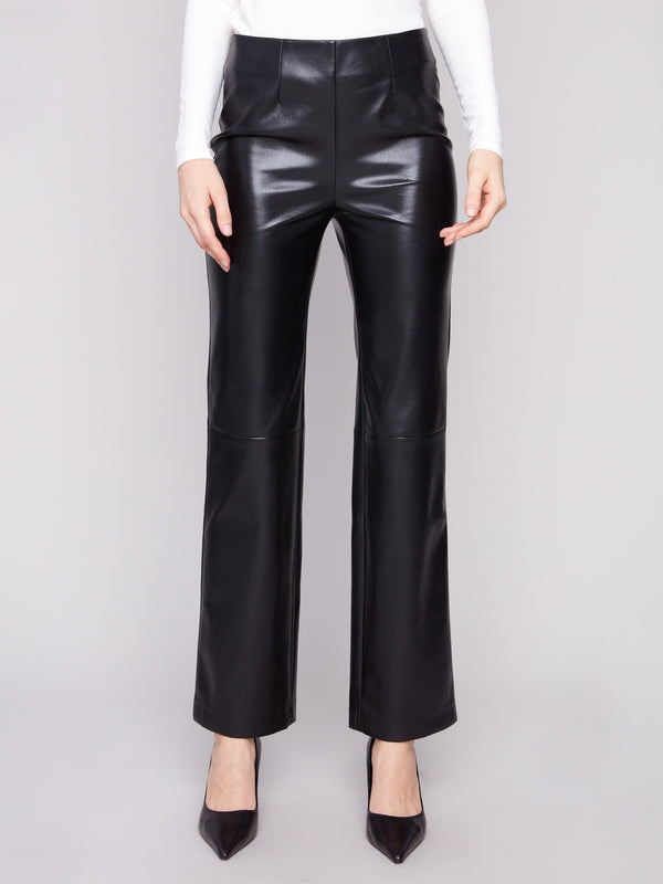 These long-length black faux leather pants feature sleek back welt pockets by Charlie B.