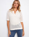 White crochet top with a stylish notch neckline and elbow sleeves, featuring a chic placket detail by Charlie B.