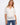 White crochet top with a stylish notch neckline and elbow sleeves, featuring a chic placket detail by Charlie B.