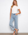 Stretch denim jeans with palm tree embroidery at the hem add a unique touch to your wardrobe. Designed by Charlie B.