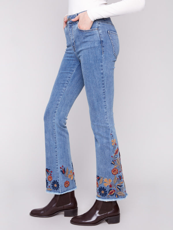 Long-length blue jeans with intricate floral embroidery on the sides, made from comfortable stretch denim by Charlie B.