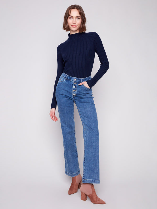 Medium blue jeans with flare fit and a dark top, featuring long length for a chic look by Charlie B.