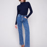 Medium blue jeans with flare fit and a dark top, featuring long length for a chic look by Charlie B.