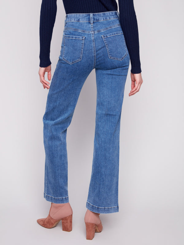 Stretch denim jeans in medium blue, styled elegantly with a dark top for comfort and flair by Charlie B.